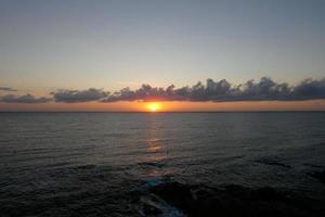 Sun disk rising over the horizon of the sea, sunrise, dawn photo