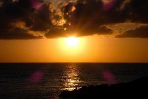 Sun disk rising over the horizon of the sea, sunrise, dawn photo