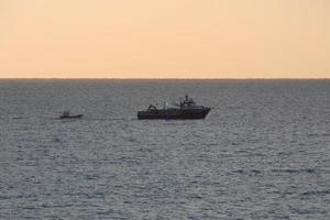 Fishermen returning from fishing at dawn after spending the whole night at sea. photo