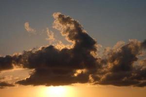 Scattered clouds in the sky indicating a change in weather. photo