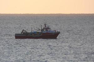 Fishermen returning from fishing at dawn after spending the whole night at sea. photo