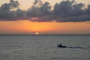 Fishing boat returning from fishing at sunrise photo