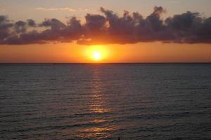 Sun disk rising over the horizon of the sea, sunrise, dawn photo