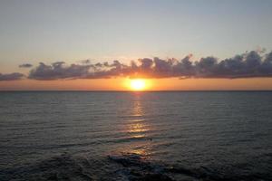 Sun disk rising over the horizon of the sea, sunrise, dawn photo