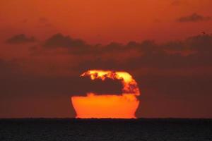 Sun disk rising over the horizon of the sea, sunrise, dawn photo