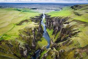 Beautiful of rugged moss Fjadrargjufur canyon with Fjadra flowing through in summer at Iceland photo