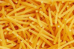 Background texture and pattern of boiled egg noodles or spaghetti pasta in full-frame format. View from above. Close-up photo