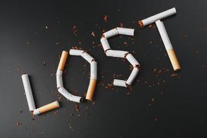 The inscription LOST from cigarettes on a black background. Stop smoking. The concept of smoking kills. Motivation inscription to quit smoking, unhealthy habit. photo