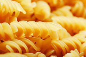 Background texture and pattern of boiled egg noodles in a spiral or pasta spaghetti screw. in full frame. View from above photo