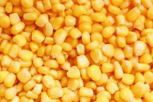 Golden canned corn, as distributed on a plane background and texture of popcorn. Before watching a movie top view. Close-up photo