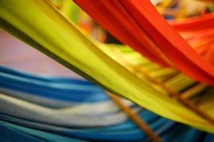 Hammocks of different colors, colors of the rainbow on the night market in Goa photo