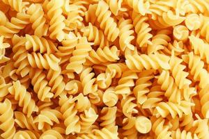 Background texture and pattern of boiled egg noodles in a spiral or pasta spaghetti screw. in full frame. View from above photo