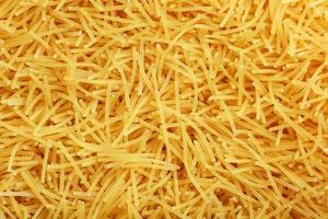 Background texture and pattern of boiled egg noodles or spaghetti pasta in full-frame format. View from above. Close-up photo