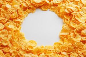 Golden Cornflakes full frame with empty round copy space in the middle as viewed from above photo