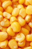 Golden canned corn, as distributed on a plane background and texture of popcorn. Before watching a movie top view. Close-up photo