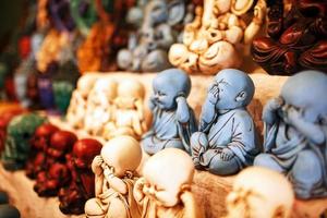 Indian gods souvenirs on the counter of the night market for tourists photo