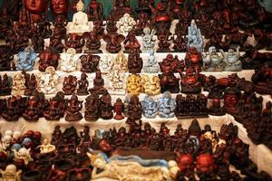 Indian gods souvenirs on the counter of the night market for tourists photo