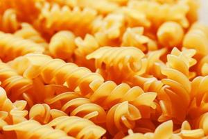 Background texture and pattern of boiled egg noodles in a spiral or pasta spaghetti screw. in full frame. View from above photo
