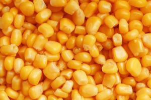 Golden canned corn, as distributed on a plane background and texture of popcorn. Before watching a movie top view. Close-up photo