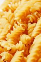 Background texture and pattern of boiled egg noodles in a spiral or pasta spaghetti screw. in full frame. View from above photo