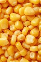 Golden canned corn, as distributed on a plane background and texture of popcorn. Before watching a movie top view. Close-up photo