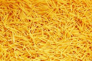 Background texture and pattern of boiled egg noodles or spaghetti pasta in full-frame format. View from above. Close-up photo