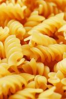 Background texture and pattern of boiled egg noodles in a spiral or pasta spaghetti screw. in full frame. View from above photo