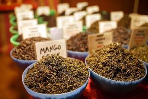 Indian green and black fruit tea on the counter of Goa night market photo