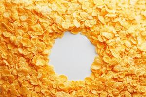 Golden Cornflakes full frame with empty round copy space in the middle as viewed from above photo