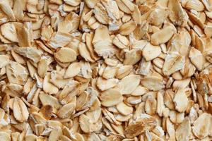 Golden cereal muesli, background and texture. Oatmeal grains. Healthy breakfast Top view. Close-up photo