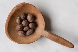 Whole Nutmeg on a Wood Paddle photo