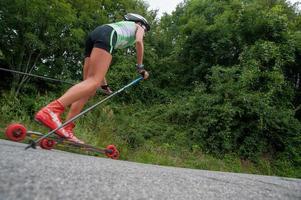 Zogno Italy 2022  Cross-country skiers train with Skiroll on uphill road photo