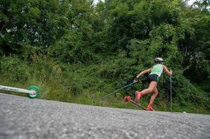 Zogno Italy 2022  Cross-country skiers train with Skiroll on uphill road photo