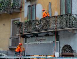 Milan 2022 Workers at work while renovating an old building photo