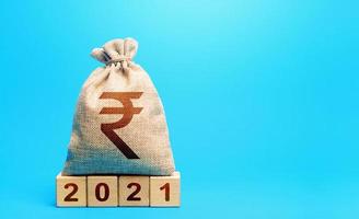 Indian rupee money bag and blocks 2021. Budget planning for next year. Revenues expenses, investment and financing. Beginning of new decade. Business plans and development prospects, trends photo