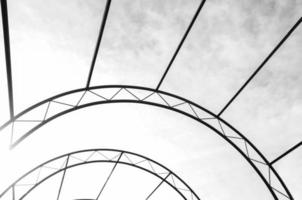 Arc metal structure on a sky background abstraction . Architecture, decorative elements. Constructive trusses. photo