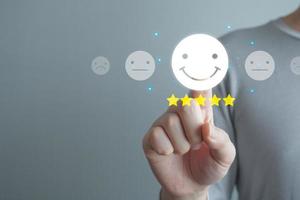 Hand touch on happy smiling face with 5 star. Positive emotion, Enjoy, World mental health day, Mental health assessment, Customer experience and service review, Satisfaction, Feedback rating. photo