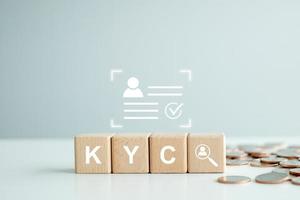 KYC on wooden cubes. know your customer with magnifying glass and customer information. Business verifying the identity of its clients concept. photo