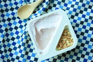 yogurt in granola Musli in a plastic packet on table photo