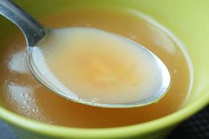 Thai hot spicy soup in bowl on table photo