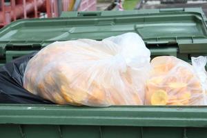 Bag with garbage and rubbish bin photo