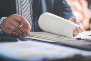 Businessman Audit documents, quality assessment management With a checklist, business document evaluation process, market data report analysis and consulting, plan review process. photo