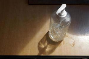 Closeup Liquid soap on wooden table photo