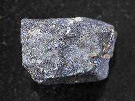 raw Molybdenite stone on dark background photo