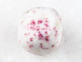 cinnabar in tumbled white dolomite stone on white photo