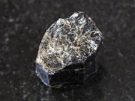 crystal of Schorl black tourmaline on dark photo