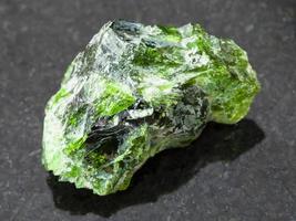 crystal of Chrome Diopside gemstone on dark photo