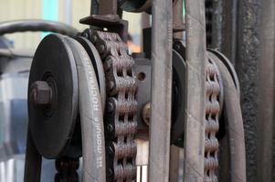 Sangatta, East Kalimantan, Indonesia, 2020 - Close up forklift chain, Oiled mechanical chain on a forklift truck photo