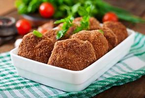 Juicy delicious meat cutlets on a wooden table in a rustic style. photo