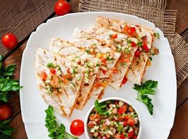 Mexican Quesadilla wrap with chicken, corn and sweet pepper and salsa photo